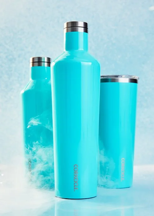 Three blue insulated water bottles with silver caps against a blue background.