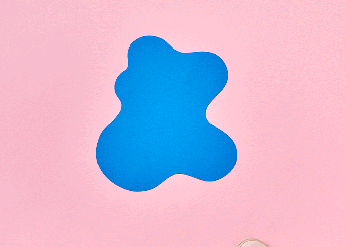 Abstract blue shape on a pink background.