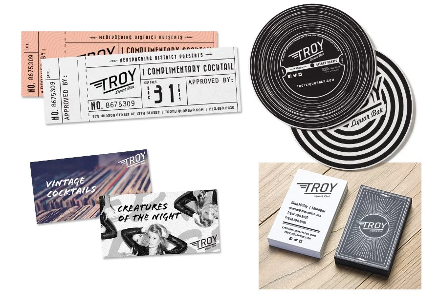Collection of vintage bar supplies, including coasters, ticket stubs, business cards, and promotional cards for Troy Liquor Bar.