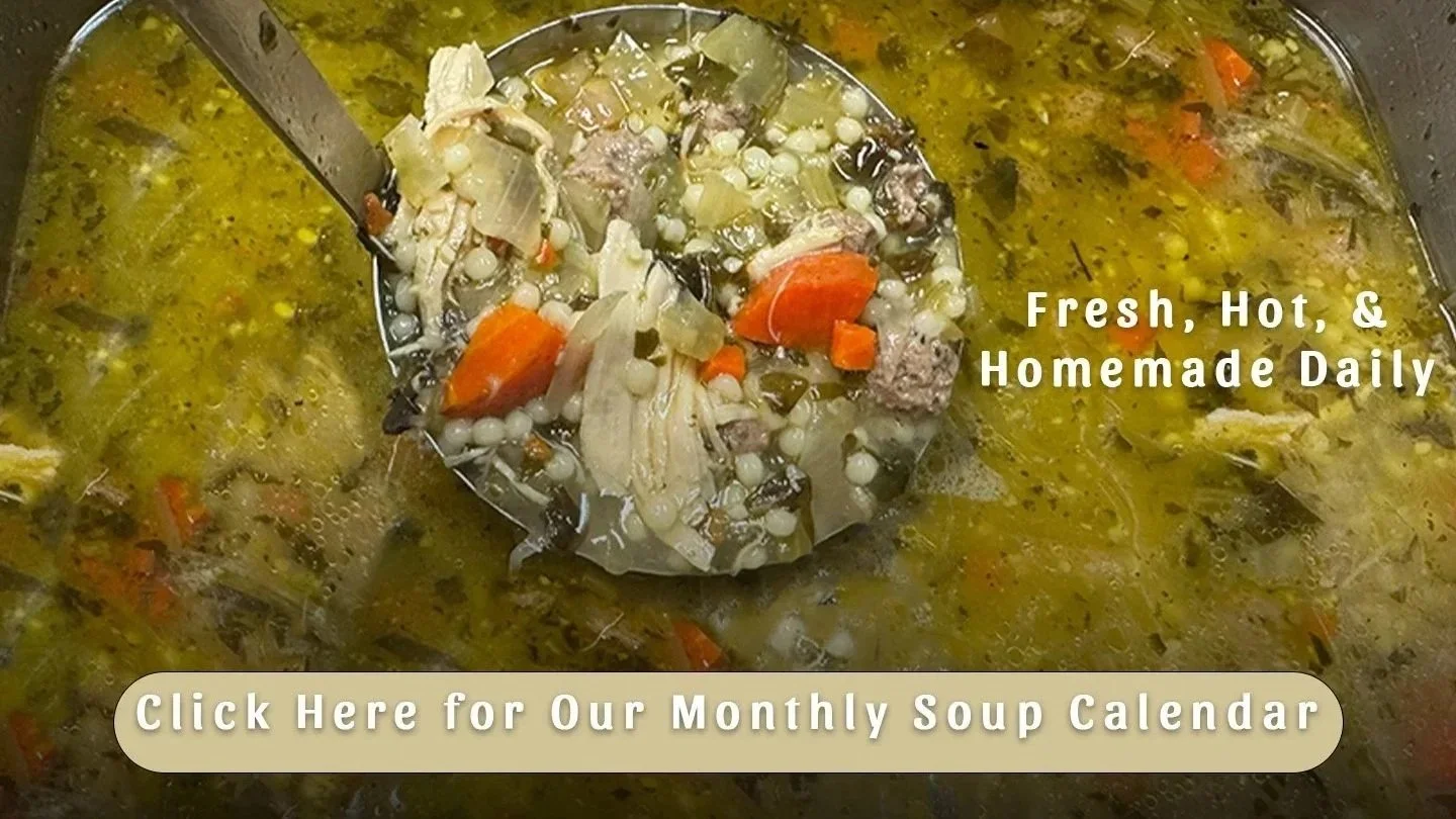 A pot of homemade chicken vegetable soup with a ladle filled with soup, showing carrots, celery, chicken, and small pasta. Text overlays say 'Fresh, Hot, & Homemade Daily' and 'Click Here for Our Monthly Soup Calendar.'