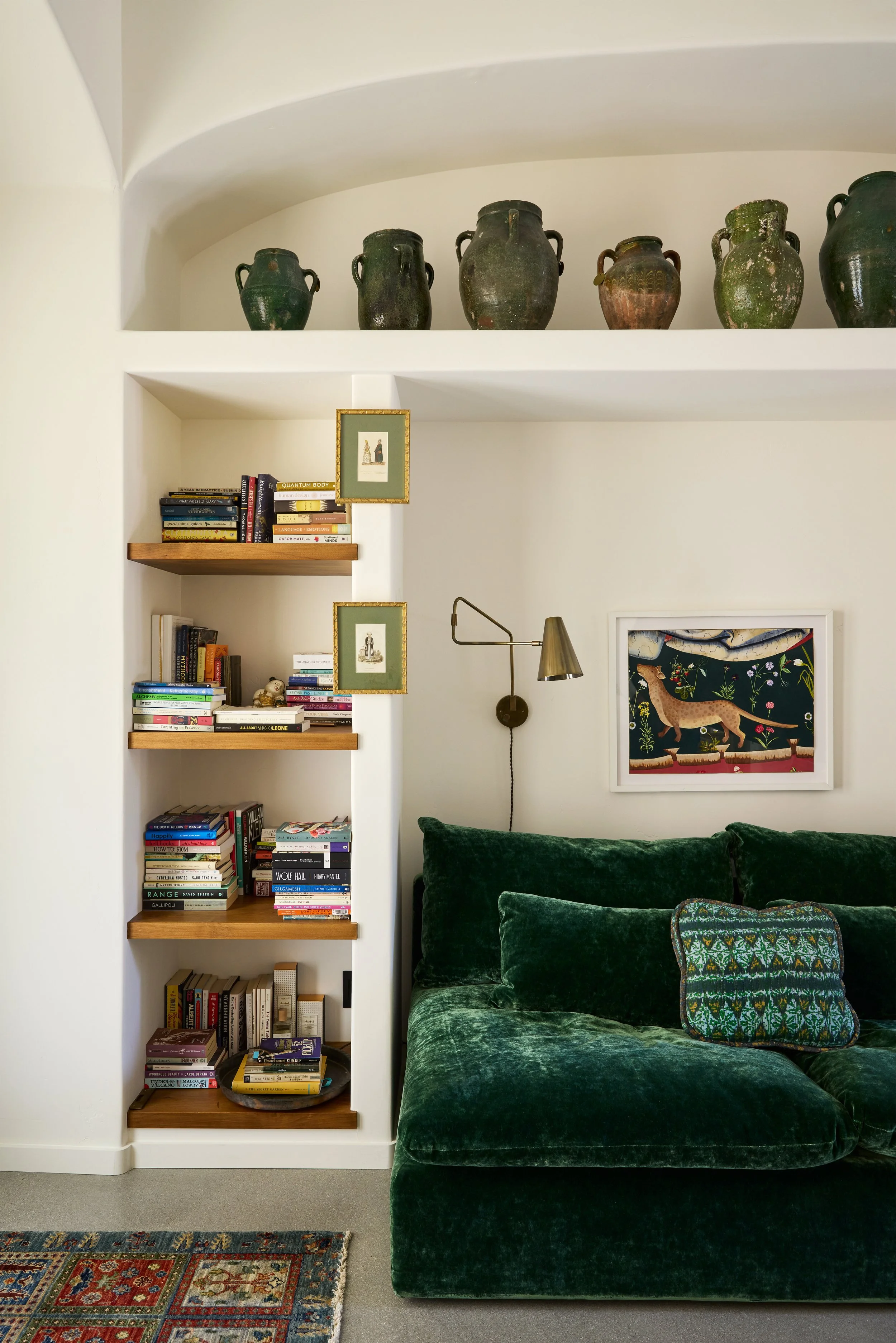 Interior by Lawren Howell with green velvet sofa and wall lighting