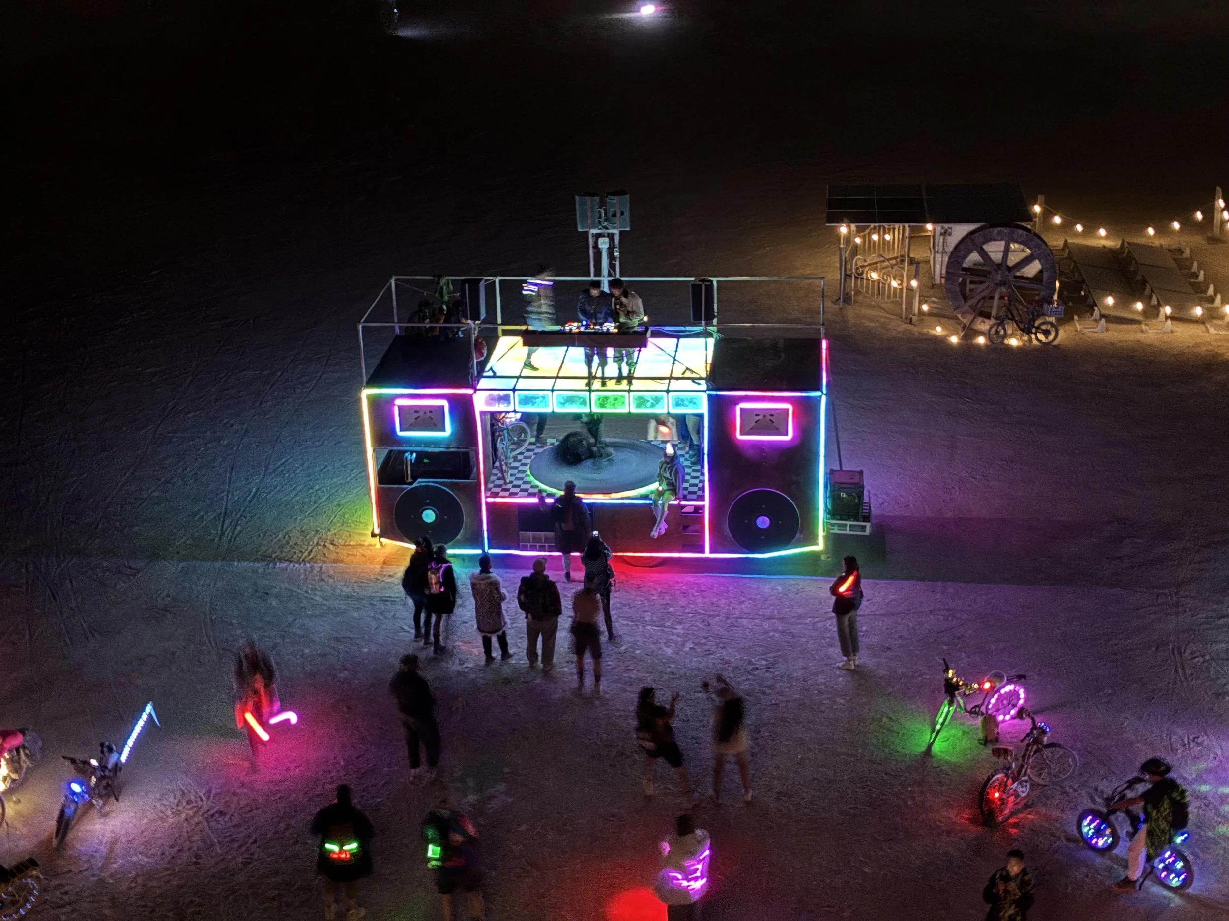 "For the Record" made its debut at Burning Man 2026 as an art car playing tribute to physical media. It features a clear dance floor, 8' diameter spinning record, and is highway legal. This was a collaboration with lighting by Matt Dohlen and project