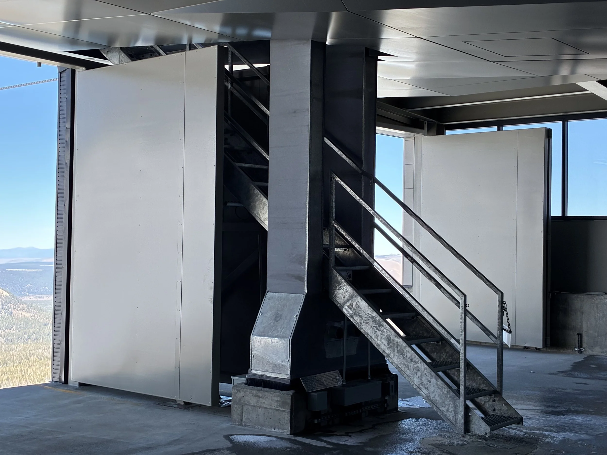 Storm doors, new CH16 and new CH1, each door measures 12' tall by 8' wide. completed under employment of Mammoth Mountain Ski Area. Scope: Design, fabrication, and installation of doors, custom bearing hinges, and lock mechanisms. Building and chairl
