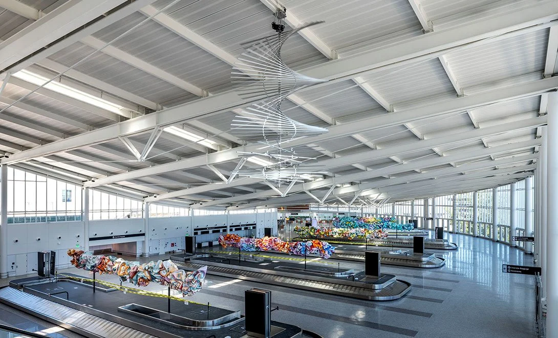 Magnetic Anomaly, Ned Kahn Studios. 12' aluminum square tubes hang on bearings from the ceiling and rotate. Scope: design and prototyping of bearing mounts, motor controls and programing. Production machining by Mendo Machine, installation by others.