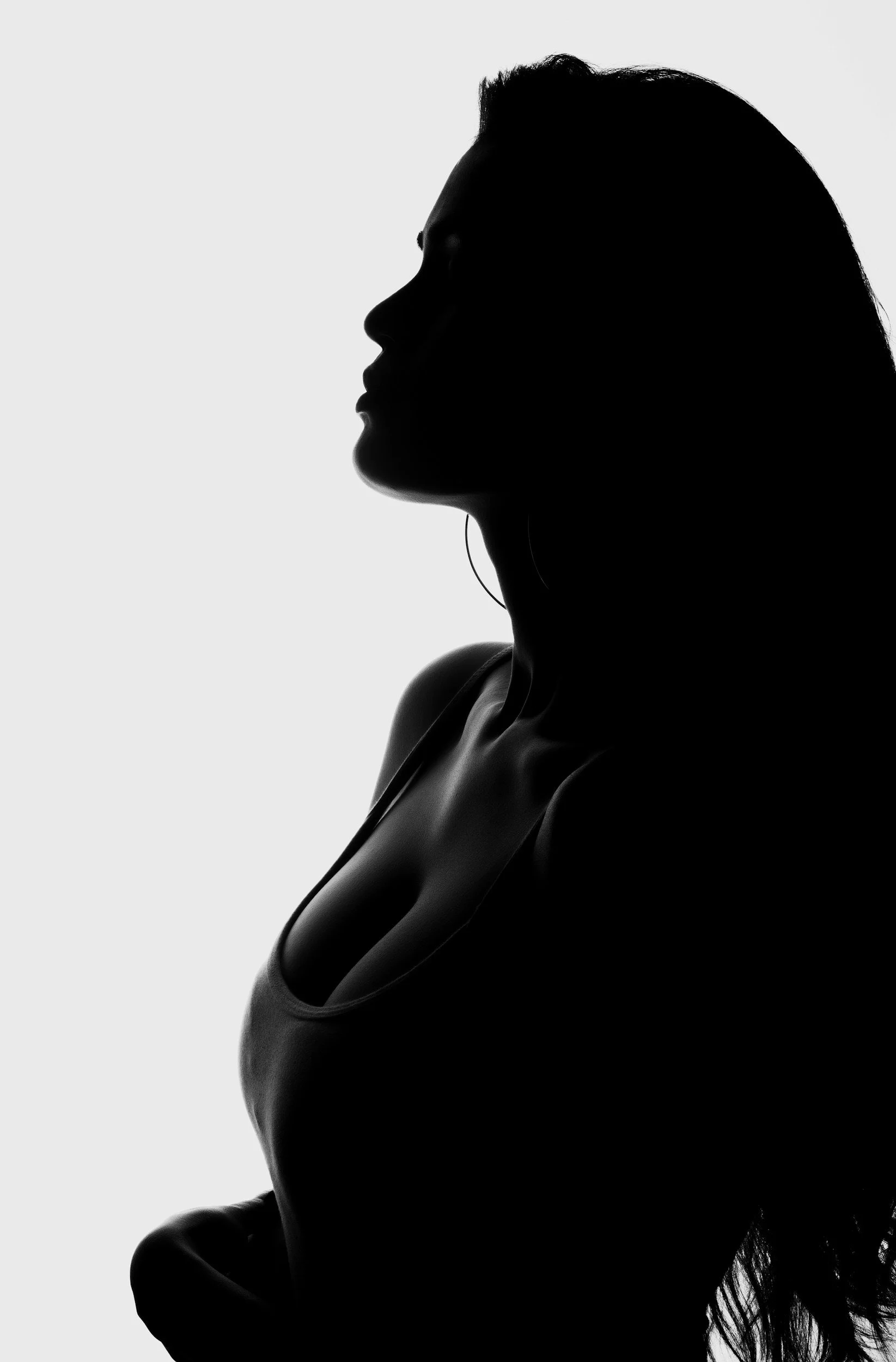 Silhouette of a woman in profile against a light background.