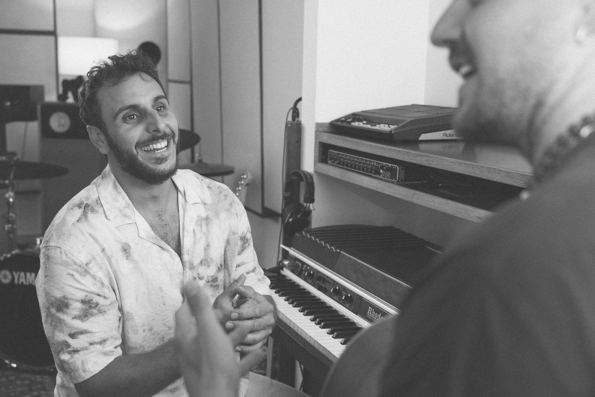 Music producer speaking with an artist during a project discussion at LevProductions.