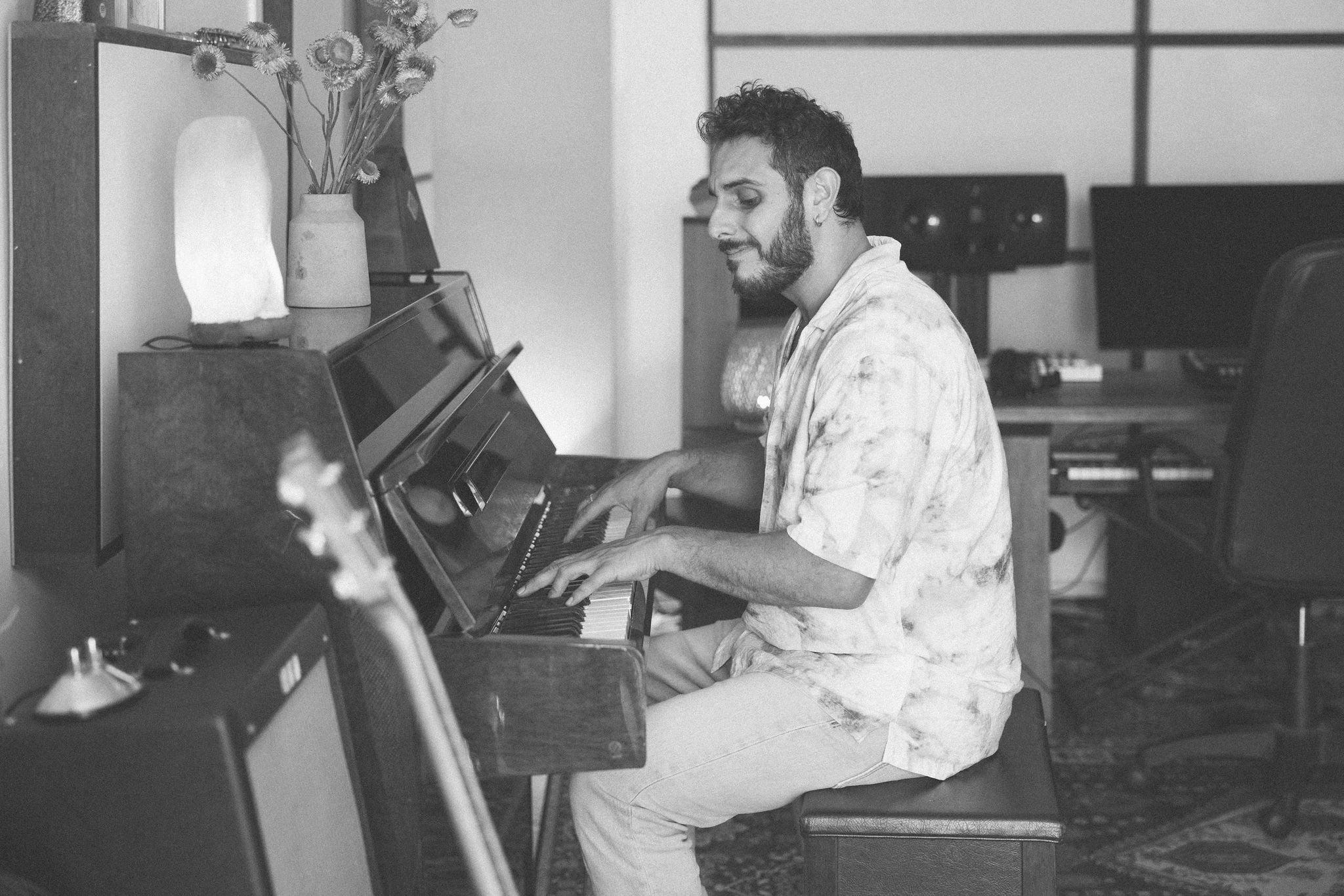 Music producer and multi-instrumentalist playing piano during a studio session at LevProductions.