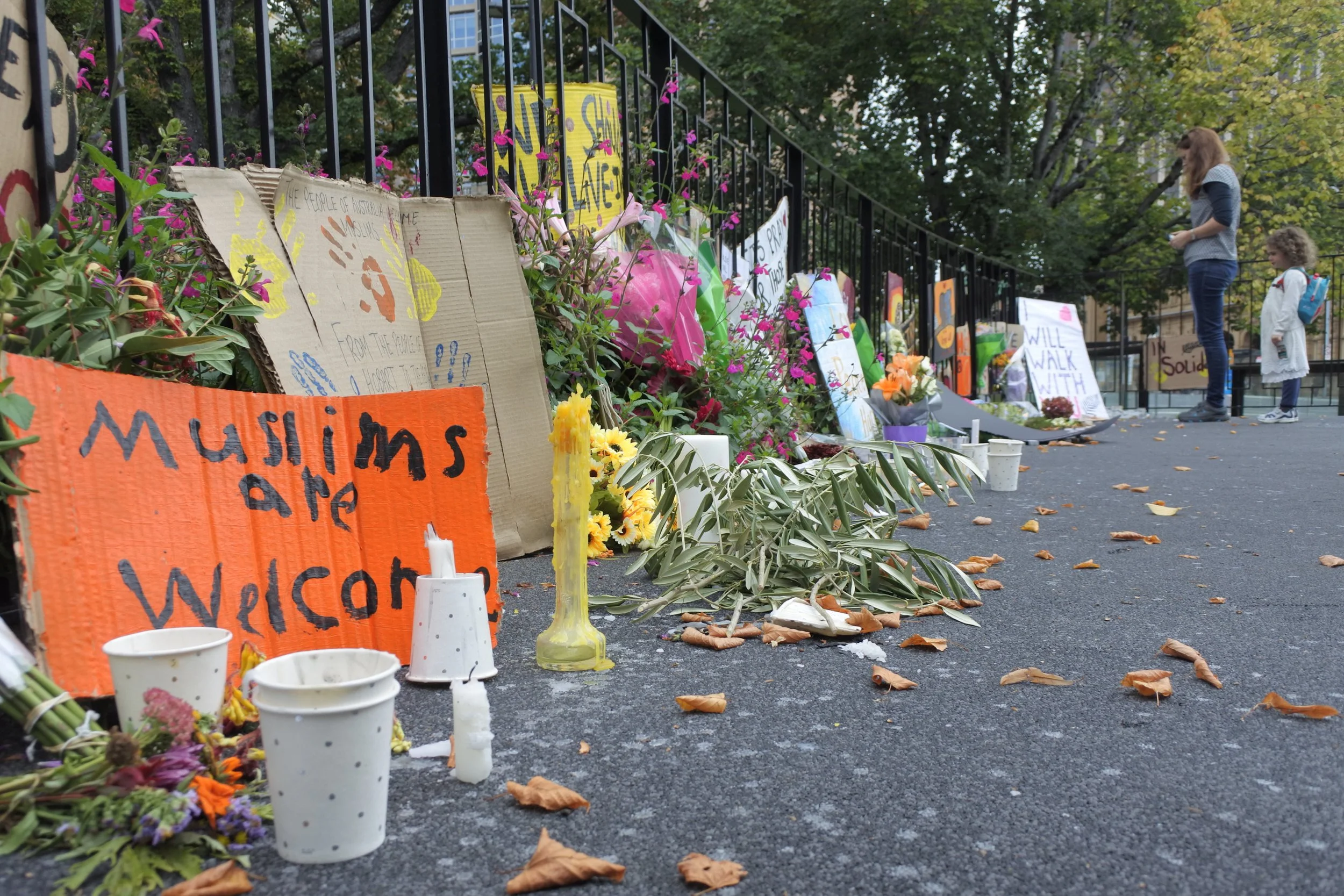 Signs flowers and candles at memorial site