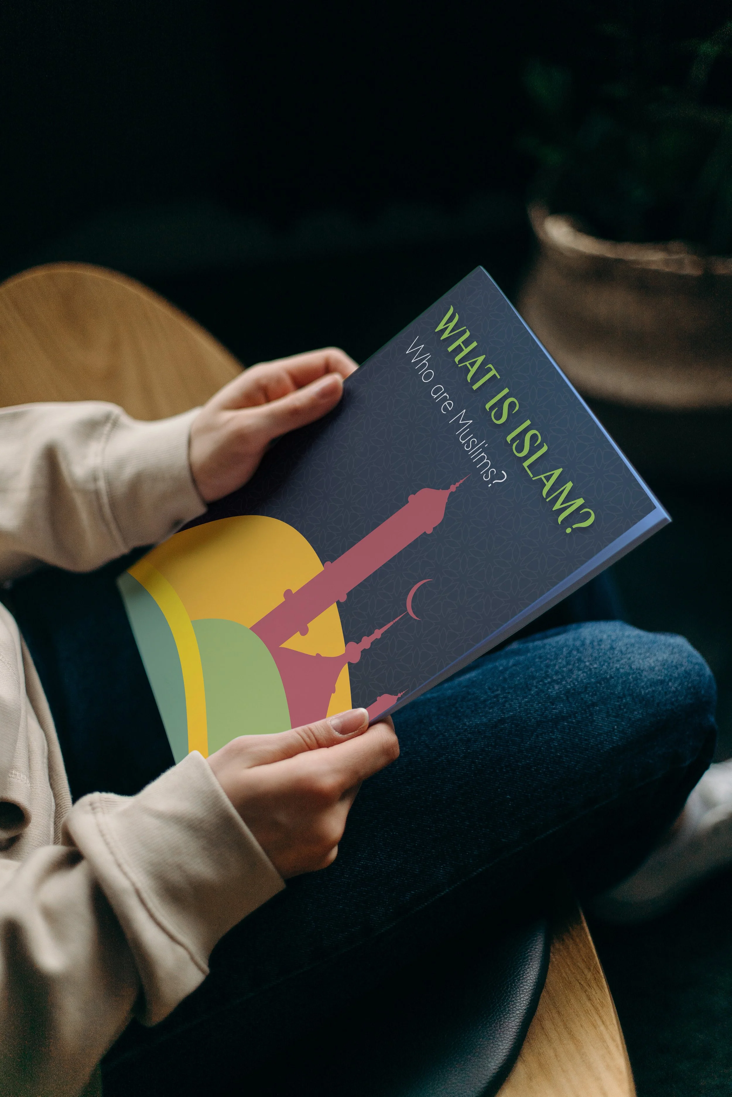 Person holding What is Islam? booklet