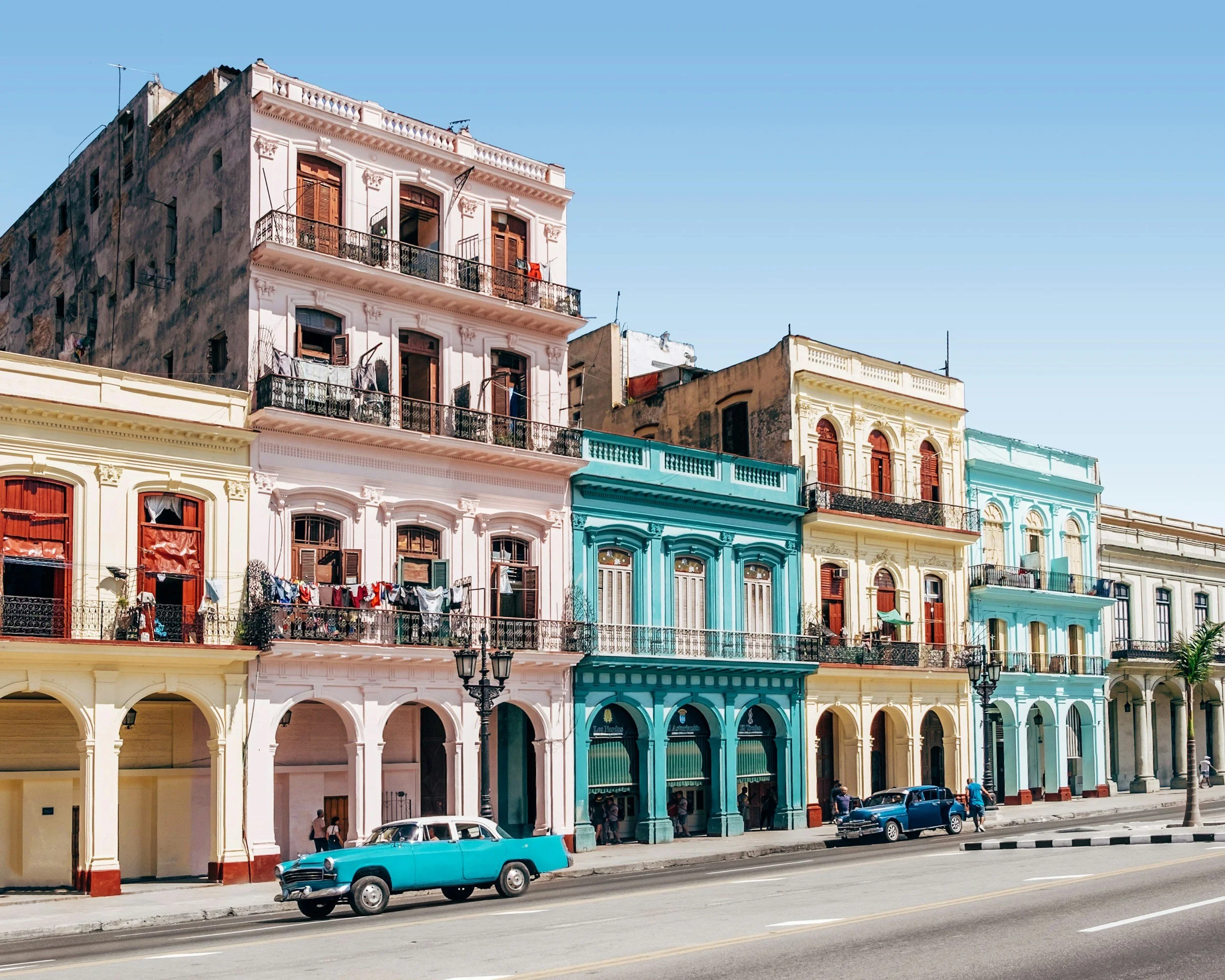 Buildings and cars in Cuba that are very colorful