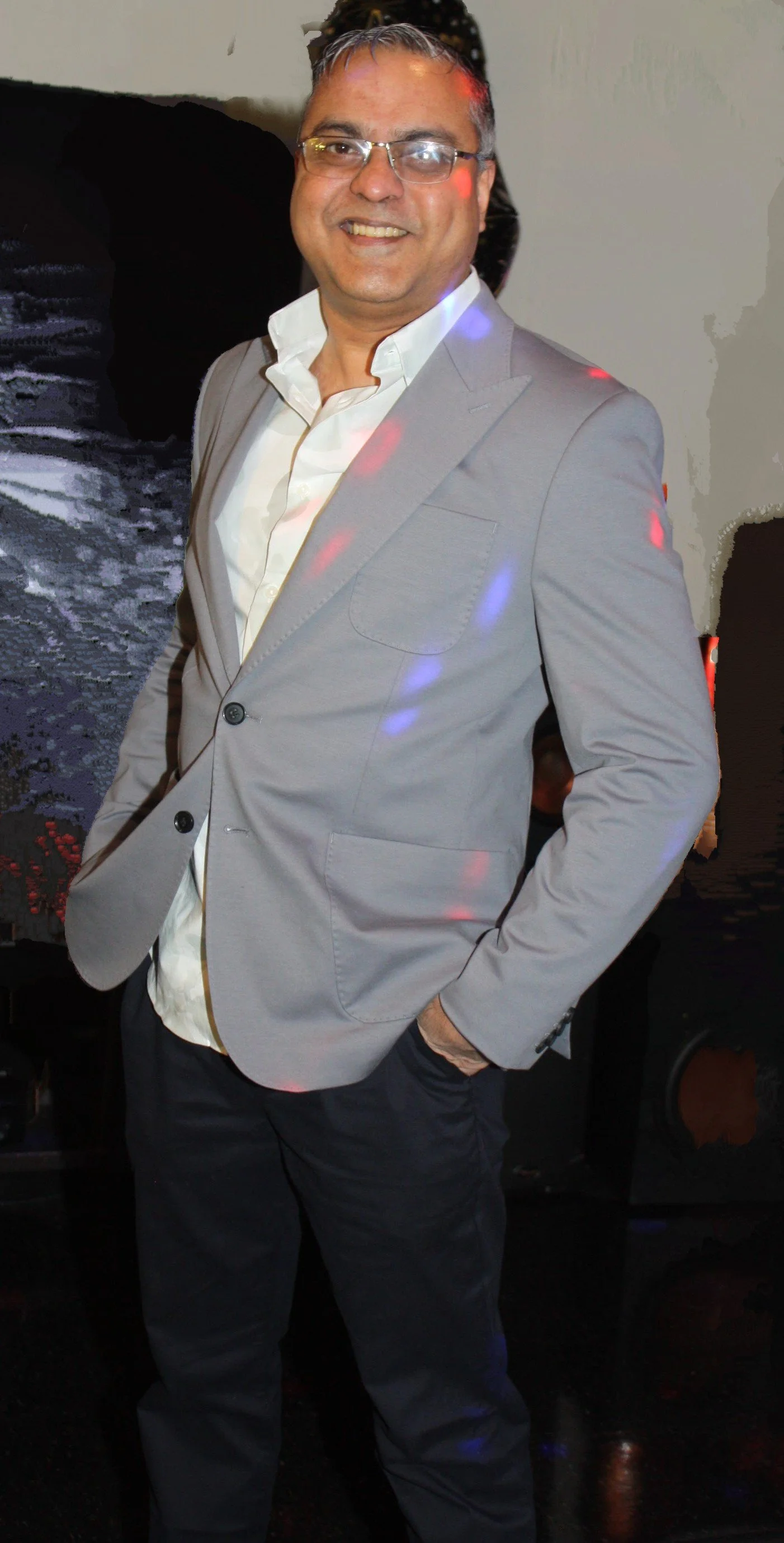 Elroy Jain New Jersey poses in a gray suit jacket