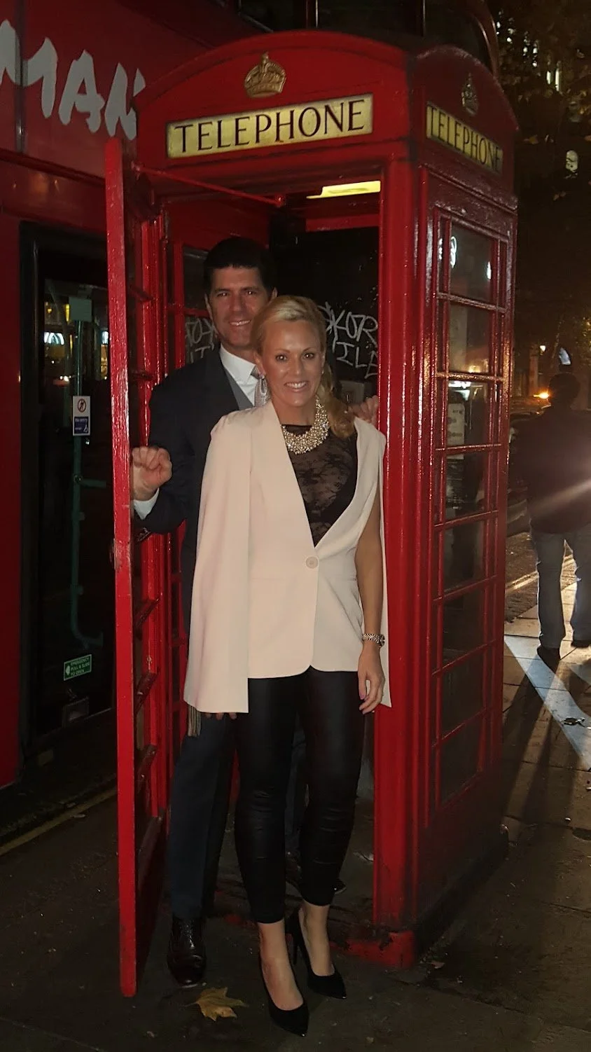 Frank Frulio Glasgow with Sally in London posing in a traditional British telephone booth