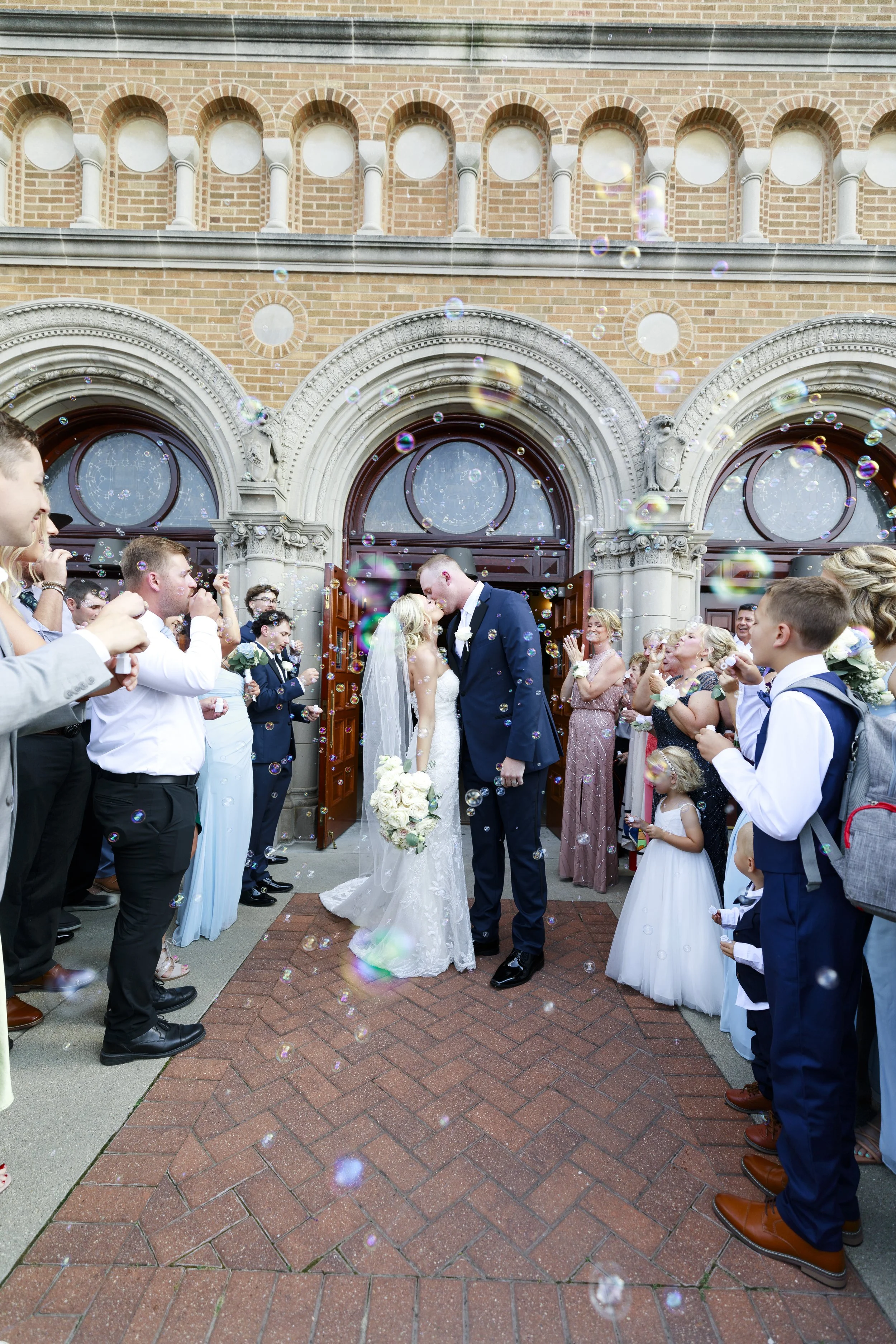 Bride and groom exiting wedding with bubble send off. Photo by Red Photography.