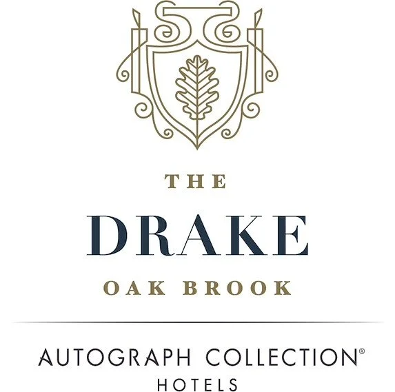 Logo for The Drake Oak Brook Hotels, featuring a crest with a leaf and decorative elements above the text