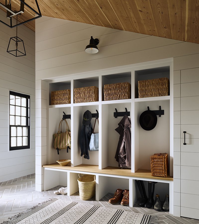 Entryway storage with hooks, baskets, and shoes.