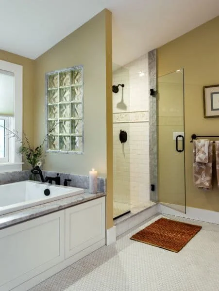 Bathroom with a bathtub, a shower, and a towel rack.