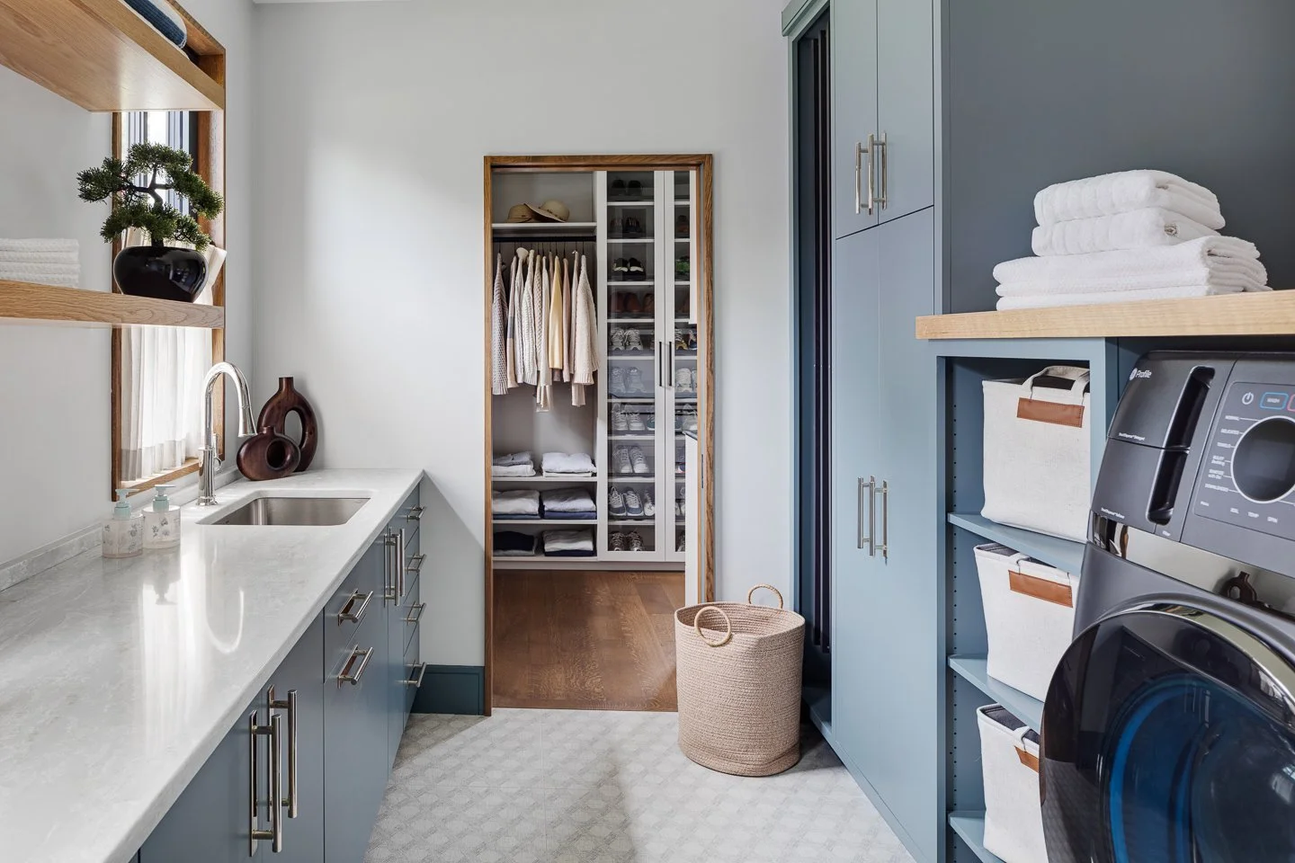 Best general contractor, home builder, and home remodeler on the Northshore in Andover, Massachusetts (MA), developed this modern primary closet and laundry room