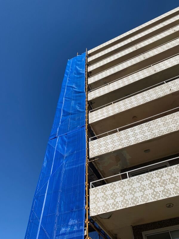 Scaffolding next to facade with original tiles.
