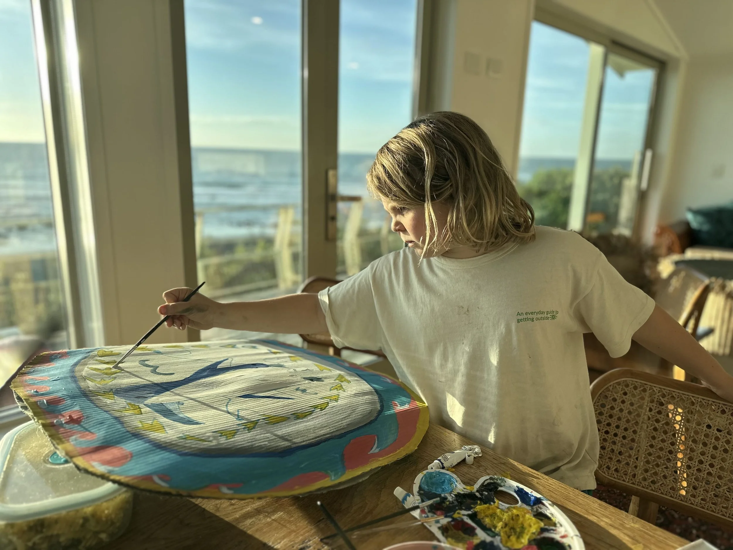 Felix painting korora sign.jpg