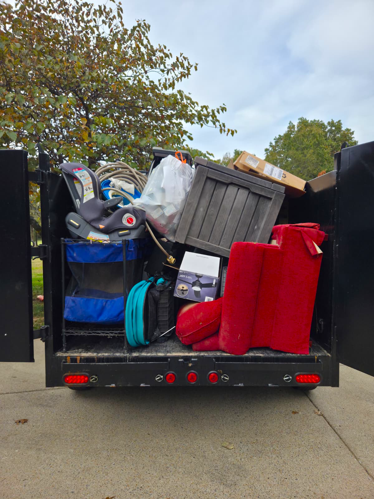Lorenz Junk Removal trailer fully loaded with furniture and debris in Nashville, TN