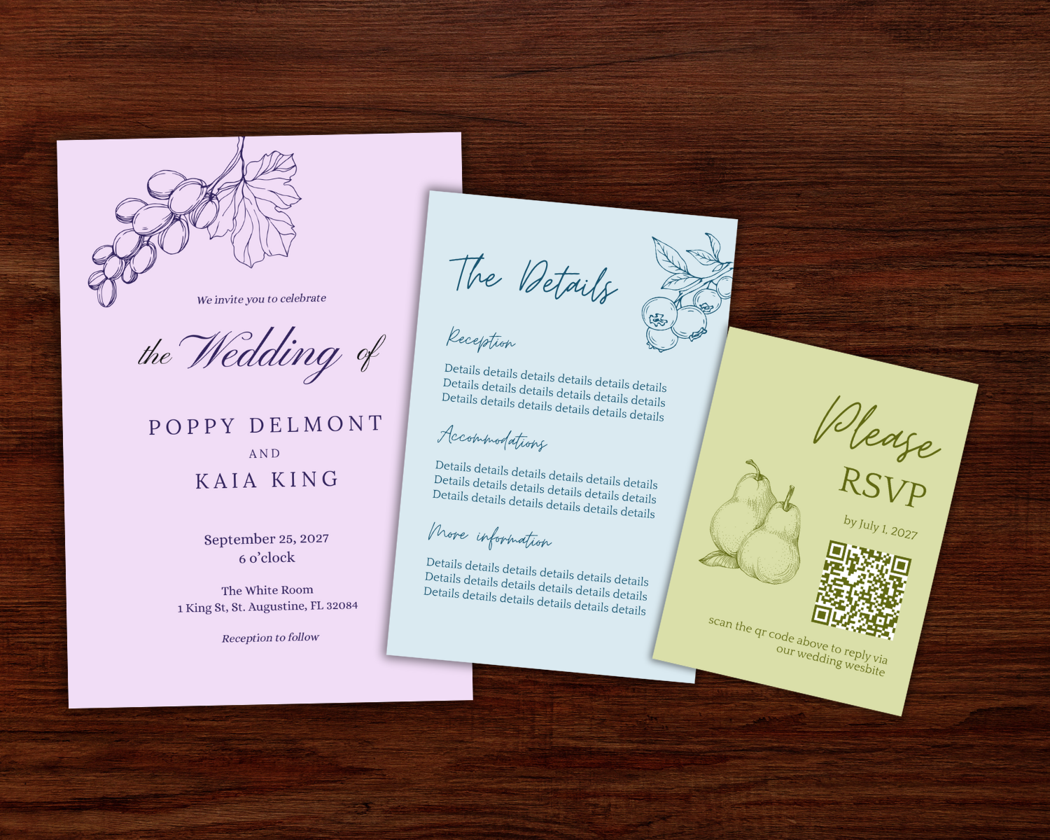 Three wedding invitation cards on a wooden surface. The first card is lavender with an illustration of grapes and details about the wedding of Poppy Delmont and Kaia King. The second card is light blue with a drawing of berries and sections titled "The Details," "Accommodations," and "More Information" with placeholder text. The third card is pale yellow with an illustration of pears, an RSVP request, a QR code, and wedding date details.