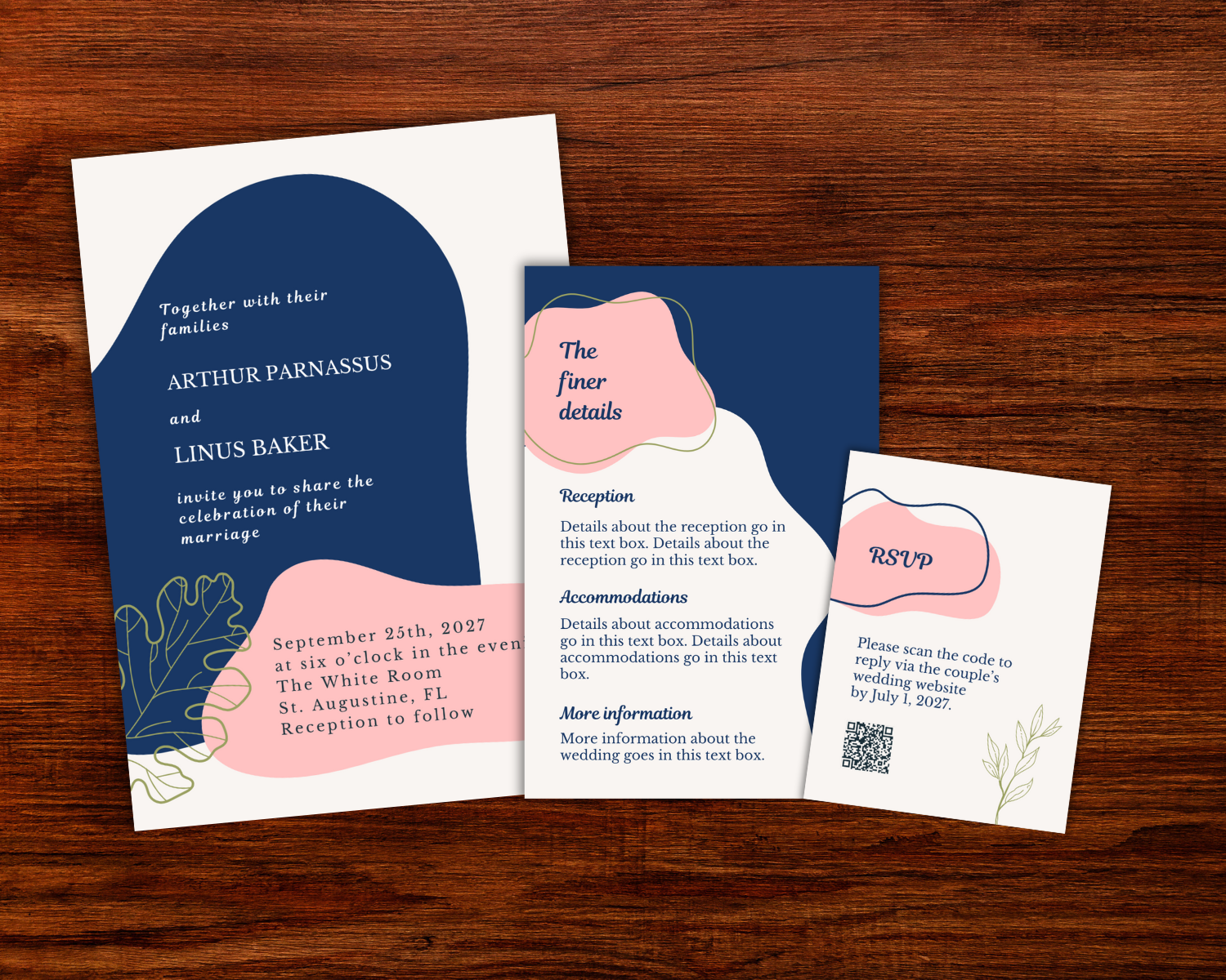 Wedding invitation cards with navy blue, pink, and white designs, including details about a wedding ceremony and RSVP instructions on a wooden surface.