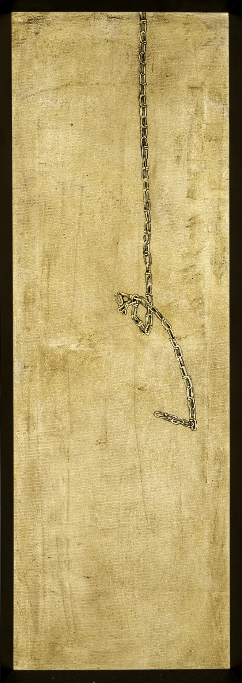 A metal chain hanging vertically against a wooden background with no other objects in view.