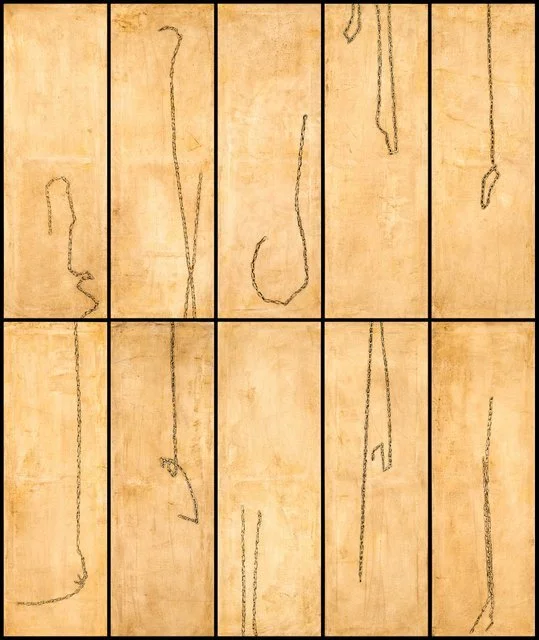 A four-by-three grid of beige wooden panels with black lines and markings, resembling floor plan sketches or ancient map outlines.