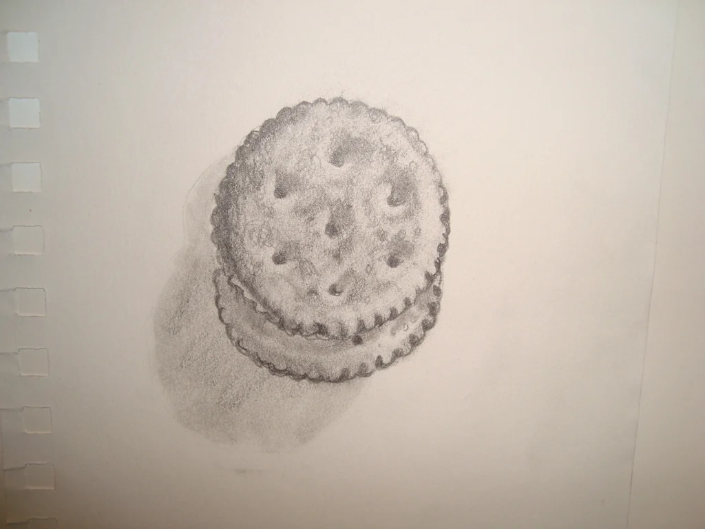 A pencil drawing of a sandwich cookie with cream filling.