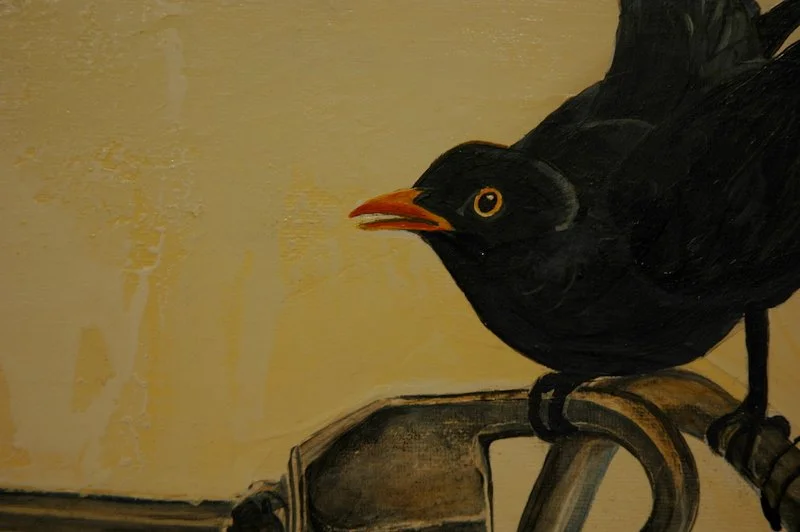 Painting of a black bird with an orange beak and yellow eye, perched on a bike handlebar against a plain beige background.