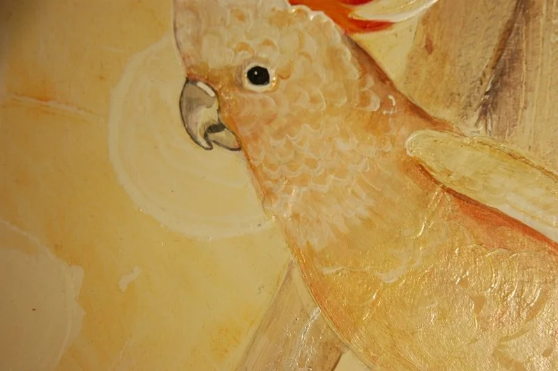 Close-up of a painting of an orange parrot with a yellow background.