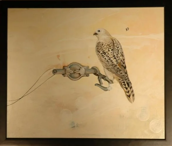 A mechanical pulley system with a bird perched on it, against a beige background.