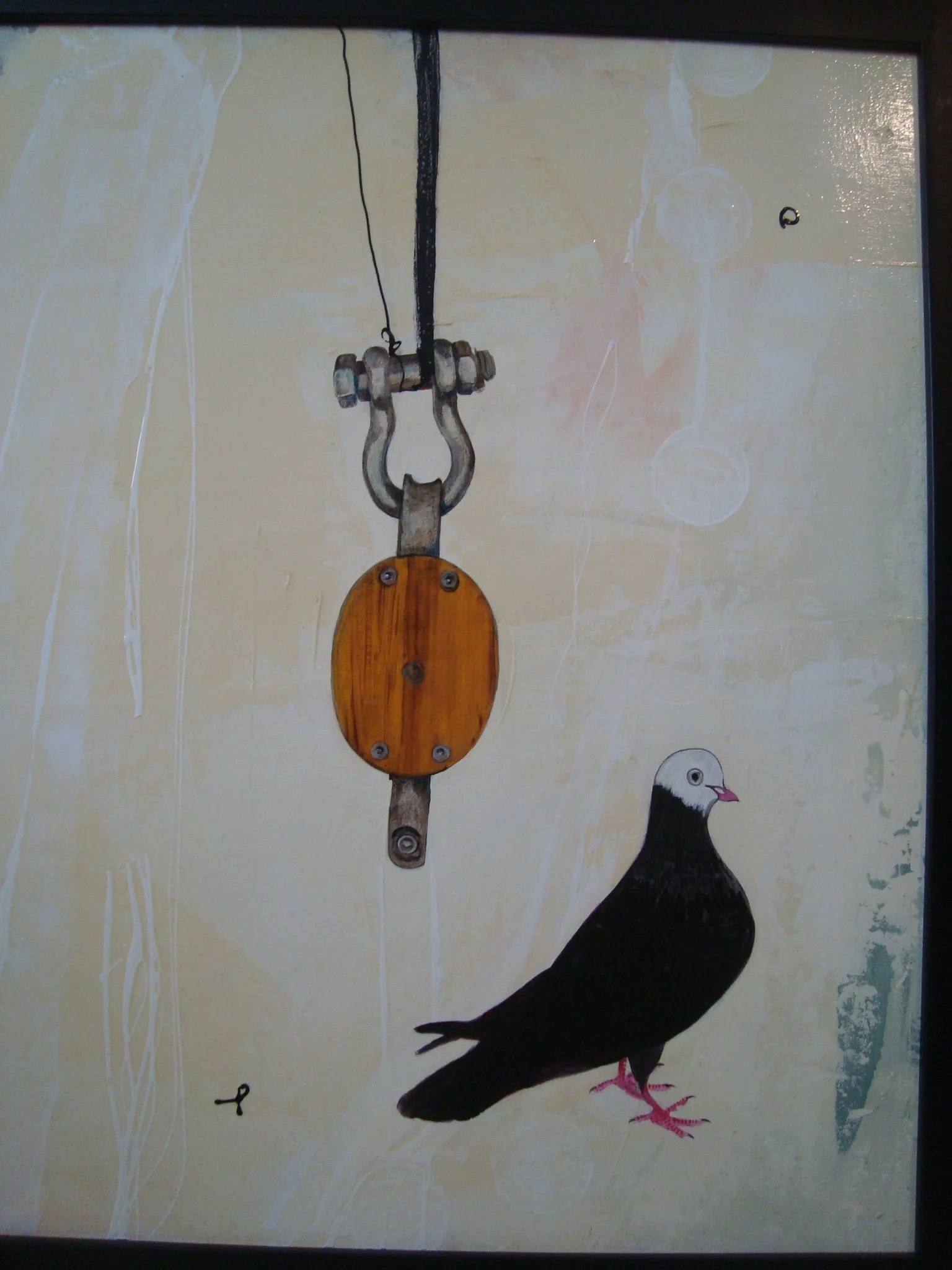 Artwork of a pulley system hanging from the ceiling with a pigeon standing below it.