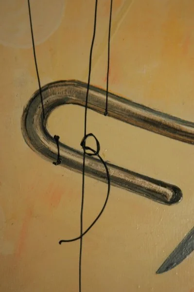 A drawing of a hook with a string hanging from it, set against a yellow and orange background.