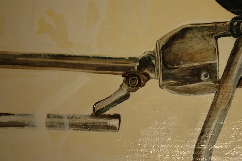 Close-up of a vintage sewing machine, focusing on the needle and metal parts.