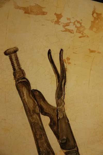 A drawing of a bolt and a rusted wrench on a peeling, beige background.