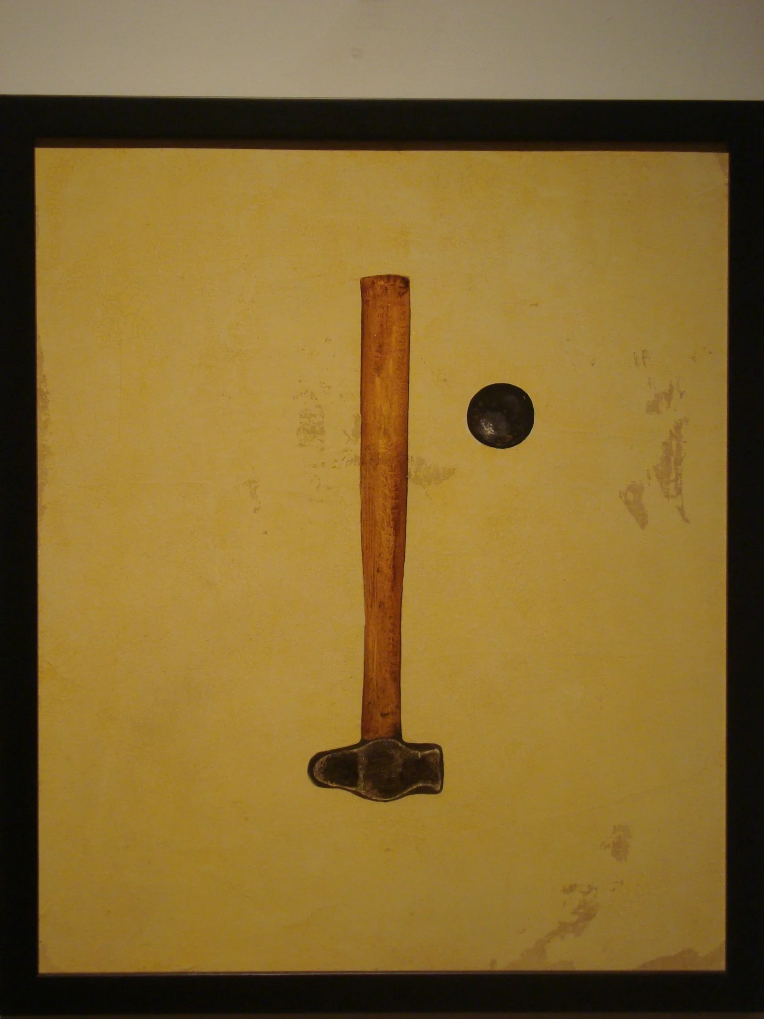 Painting of a hammer and a small black circle on a yellow background.