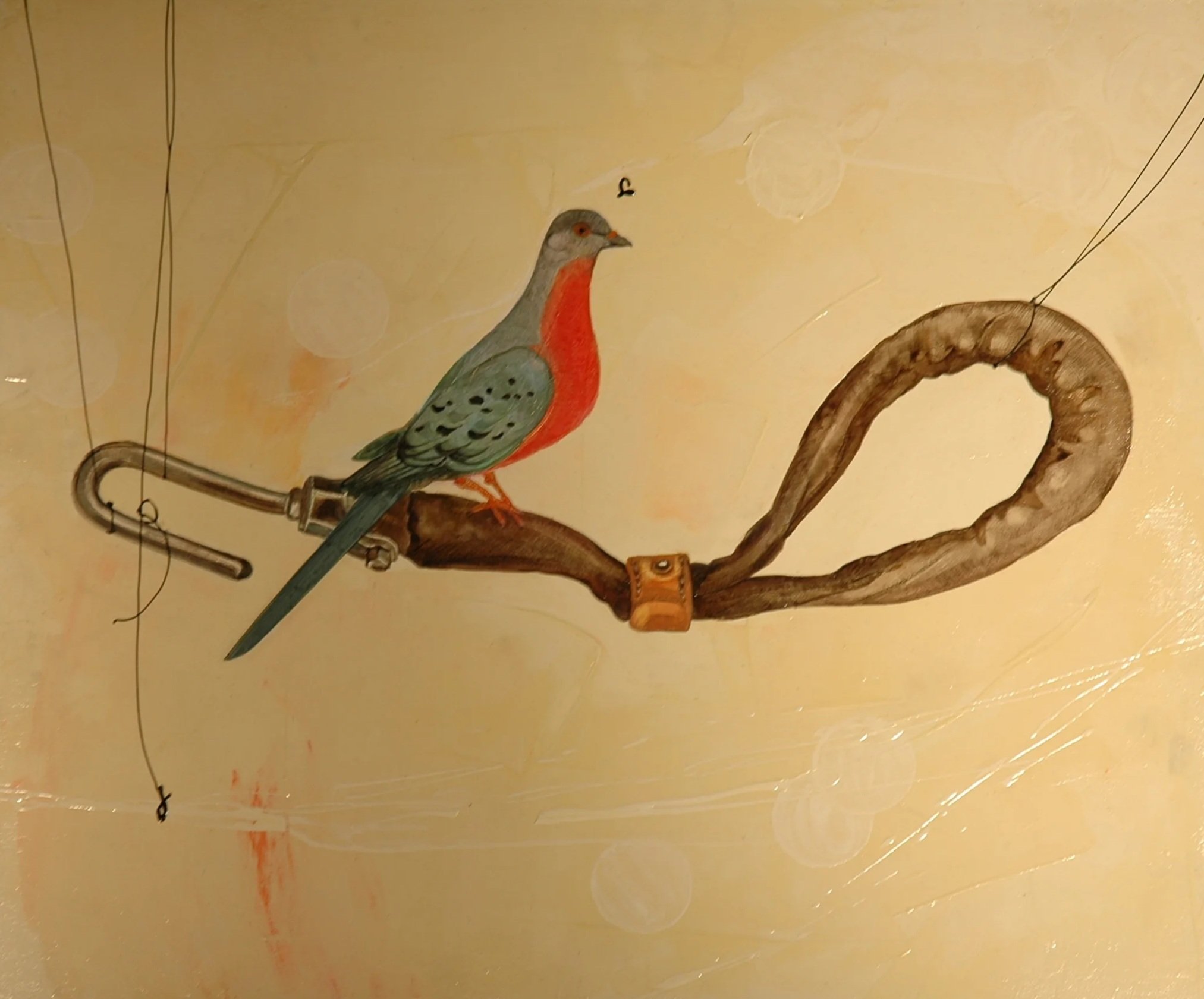A painted bird perched on a branch with a looped extension, against a yellow background.