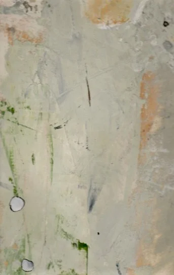 Close-up of a weathered, painted wall with peeling paint, scratches, and some green and black marks.