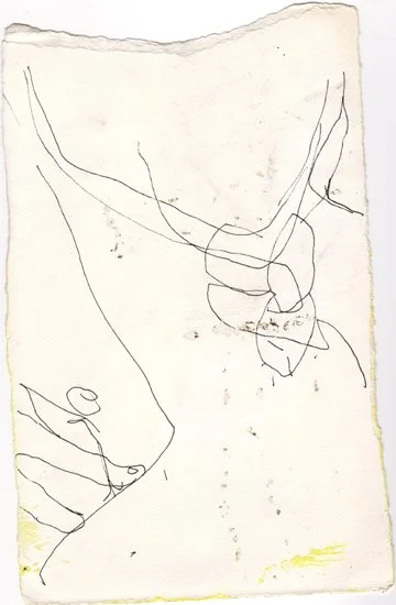 A simple, childlike line drawing of a face on a piece of paper.