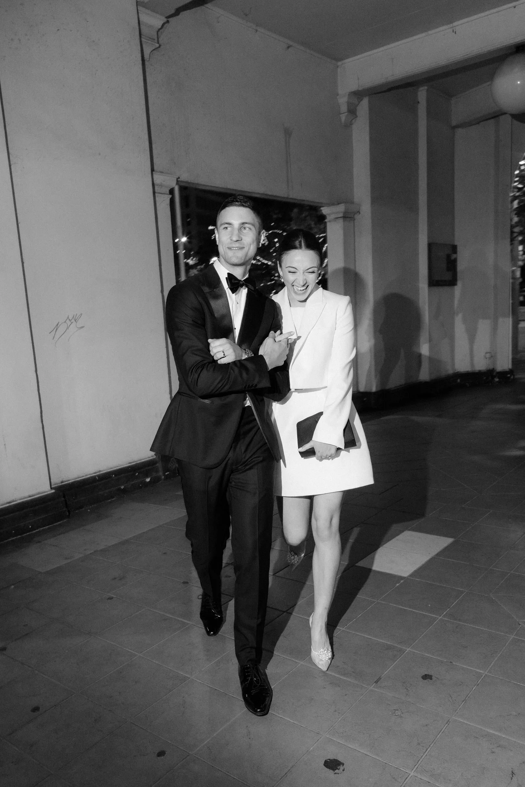 Newlyweds entering their Bar Rochford wedding reception after a National Gallery of Australia ceremony, captured by Corinna & Dylan