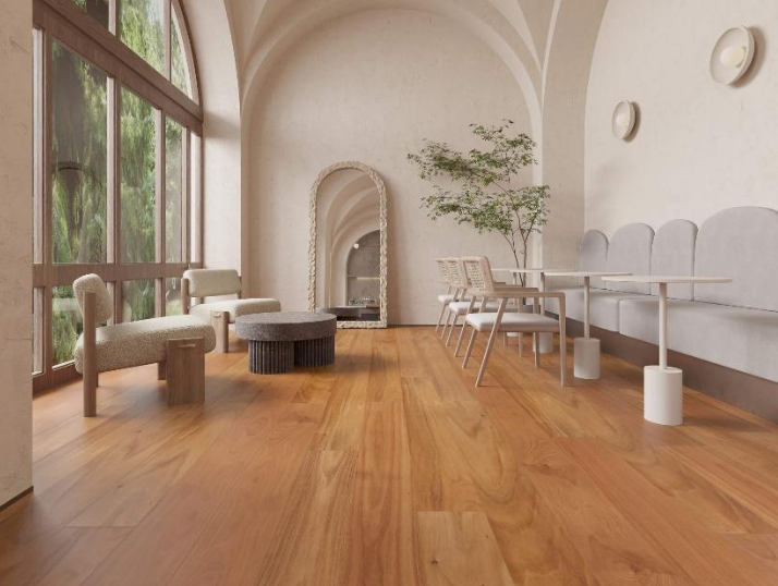 Minimalist living room with large windows, wooden floor, beige walls, and simple furniture including chairs, a round ottoman, a fireplace, a dining table with chairs, and a potted plant.