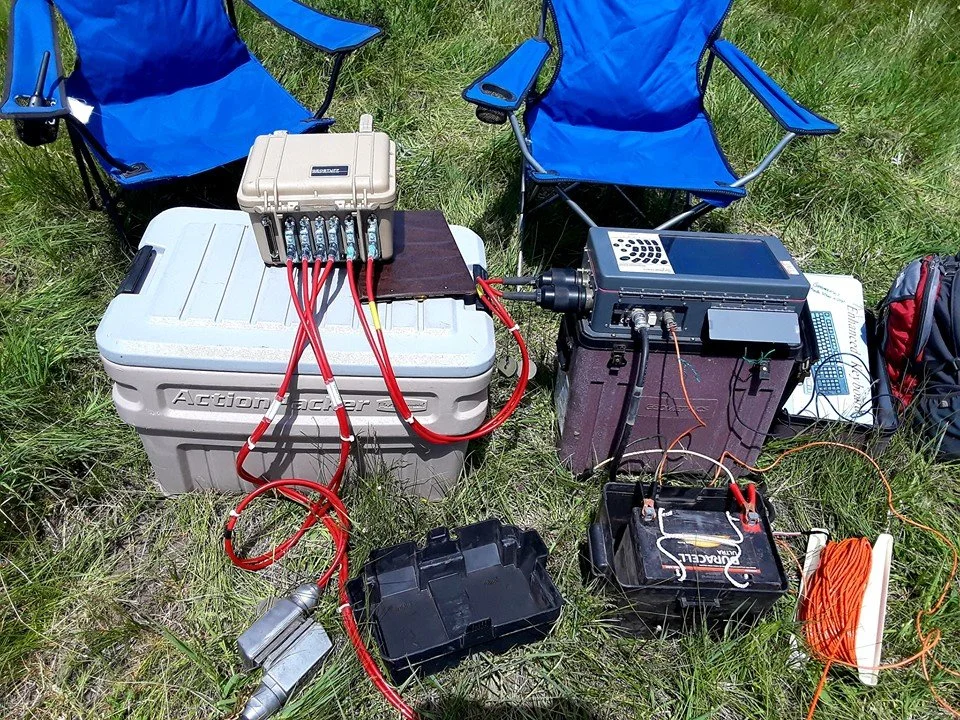 SAGE, Summer of Applied Geophysical Experience. Scientific equipment set up outdoors on grass.