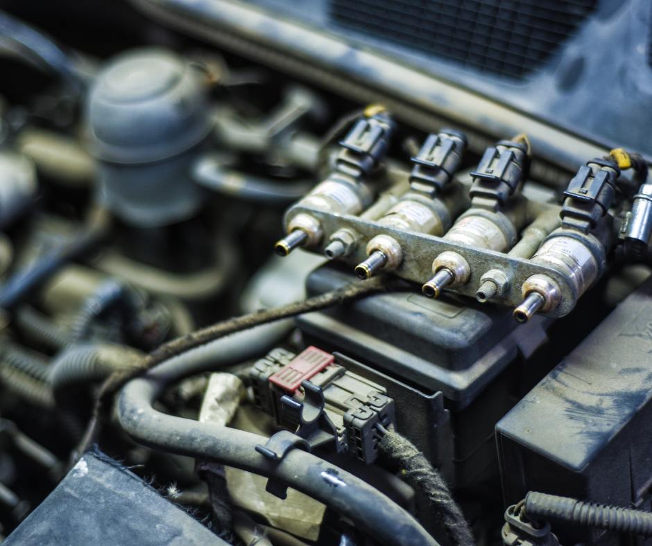 Close-up view of a car engine with fuel injectors and related components.