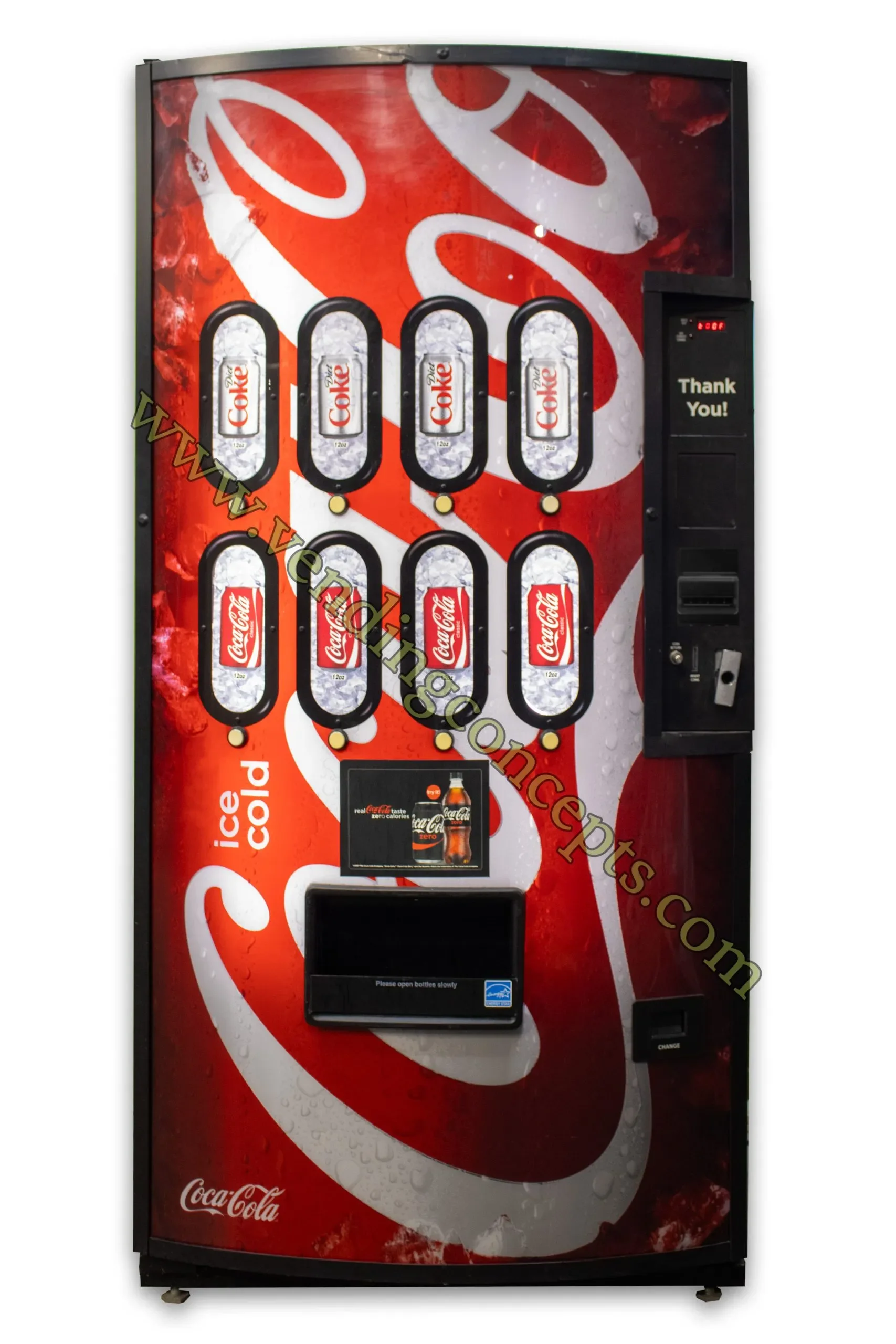A Coca-Cola vending machine with a red and white design, offering cans of Coca-Cola and Diet Coke, with a coin slot, digital display, and a small screen for advertising.