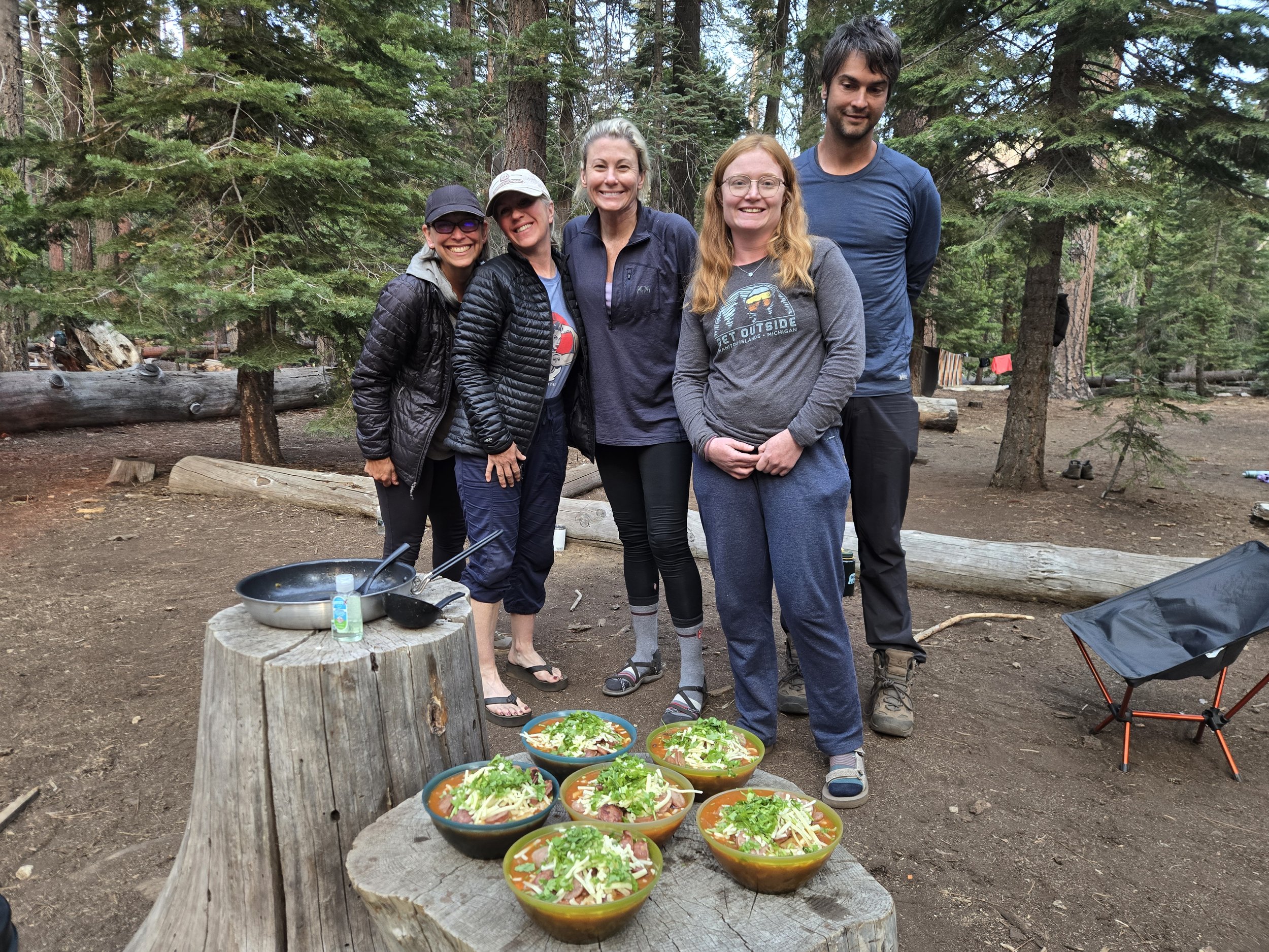 Backpackers sharing a meal at camp during an Axis Wild Expeditions guided adventure