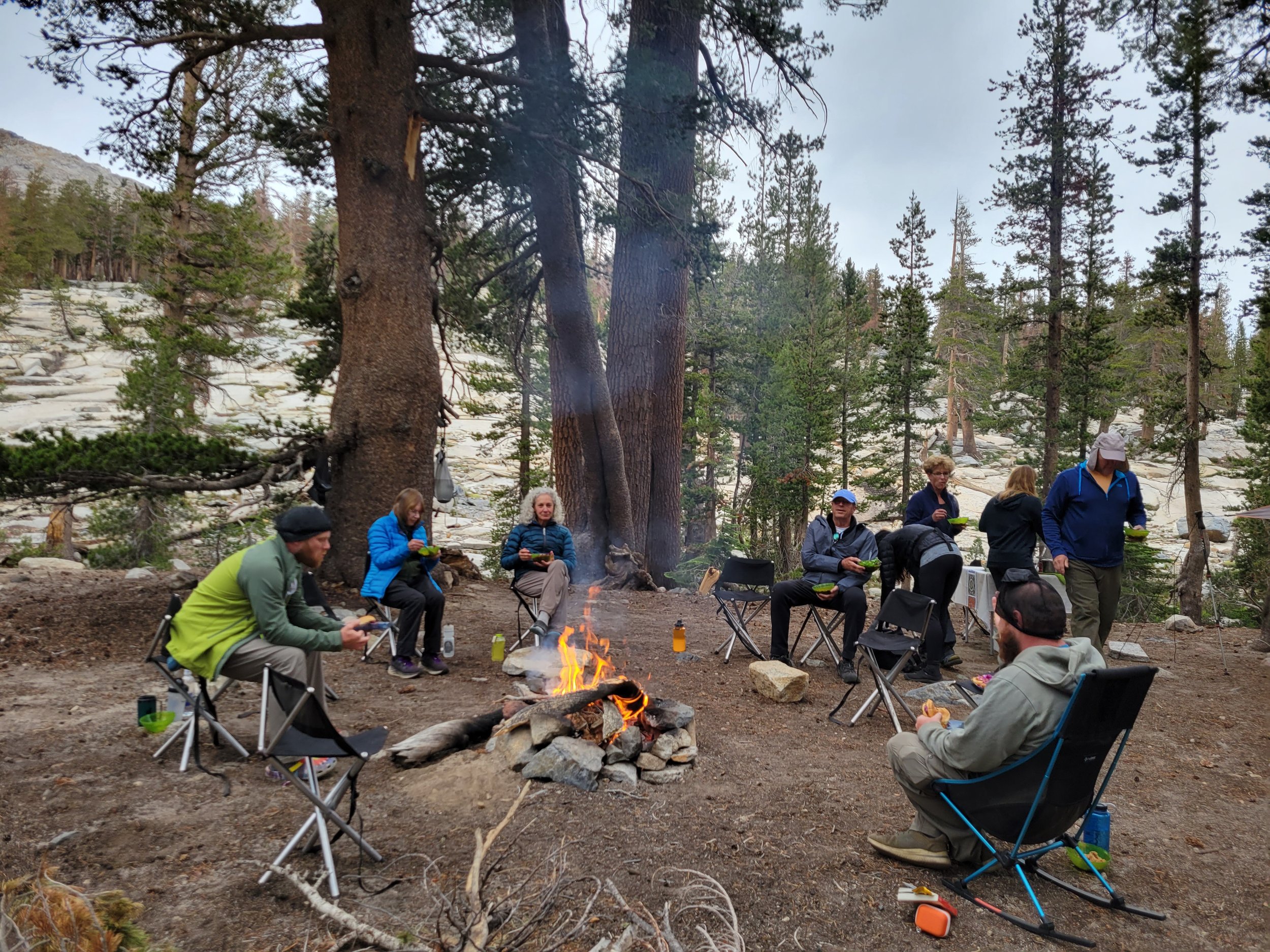 Lady lake eaating around fire.jpg