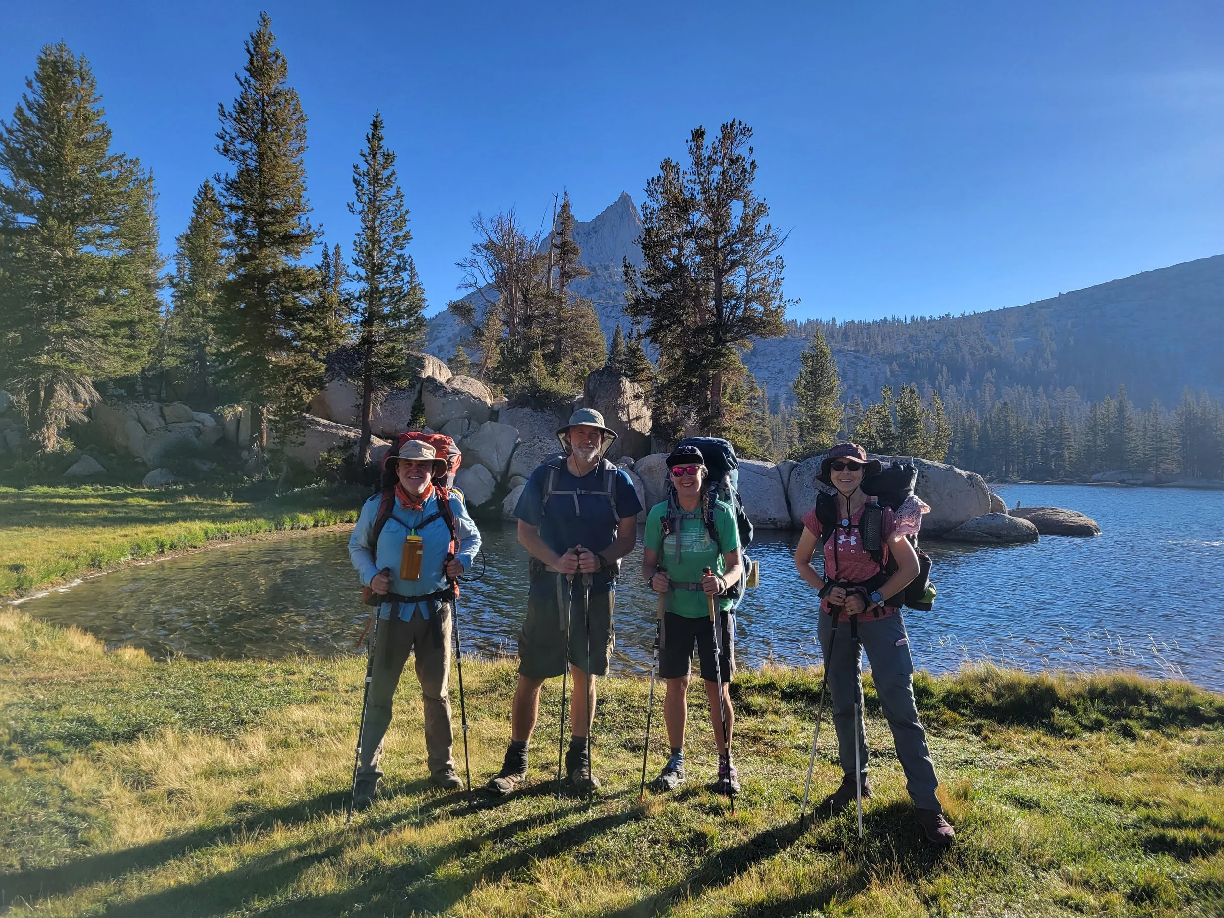Backpackers standing next to Cathedral Lake in Yosenmite.