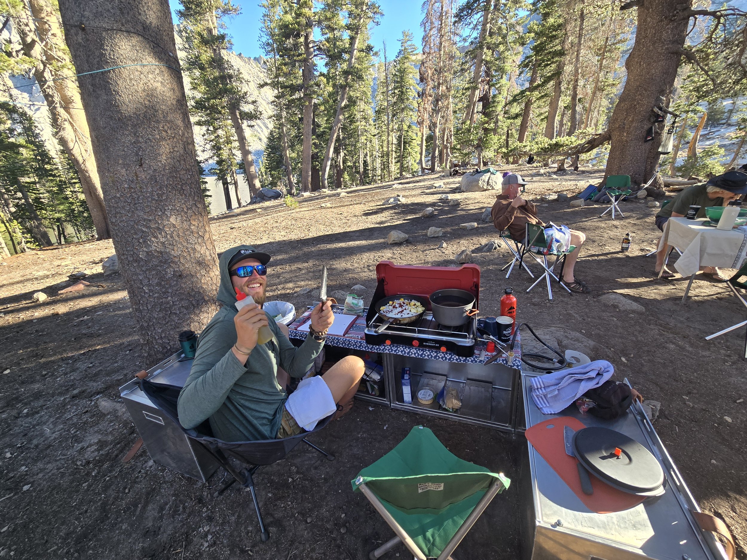 Axis Wild Expeditions guide preparing a fresh backcountry dinner in the Sierra Nevada