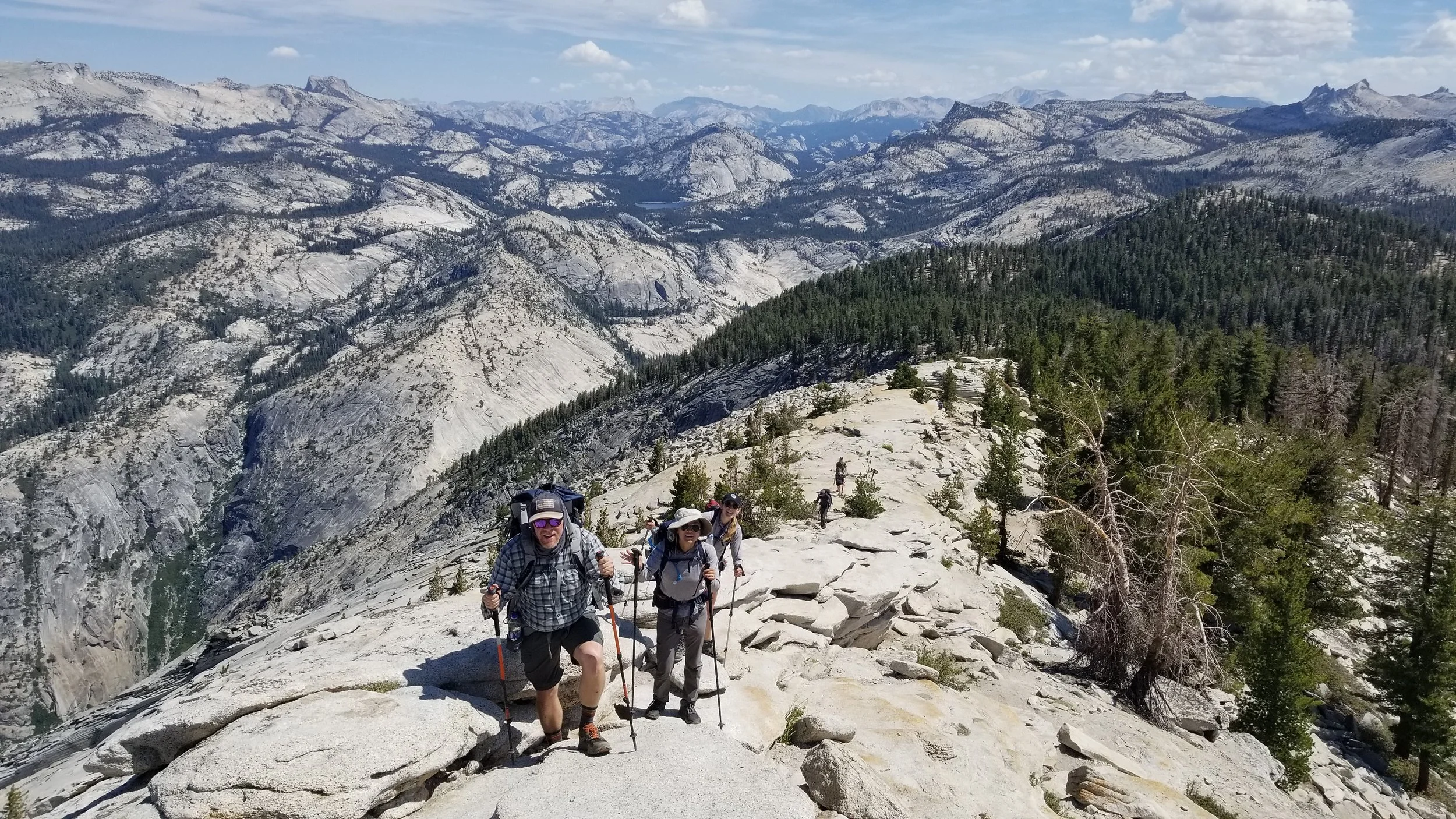 Hikers climb up Clouds Rest